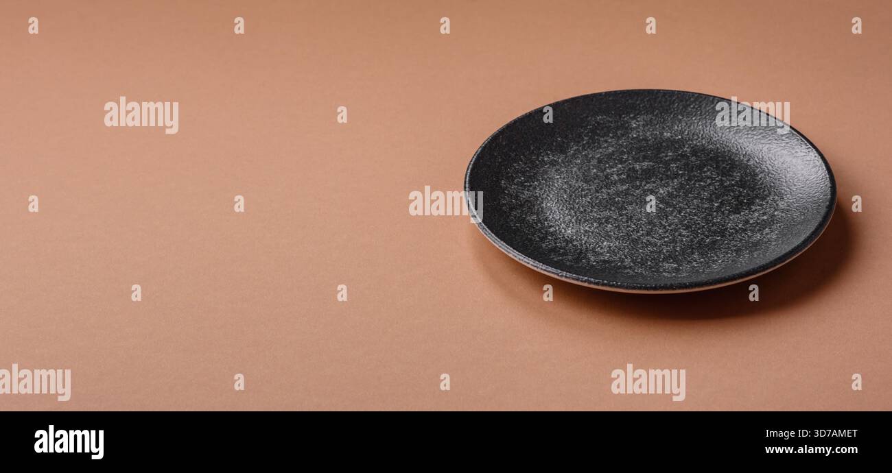 An empty round ceramic plate on a table, kitchenware. An empty plate as ...