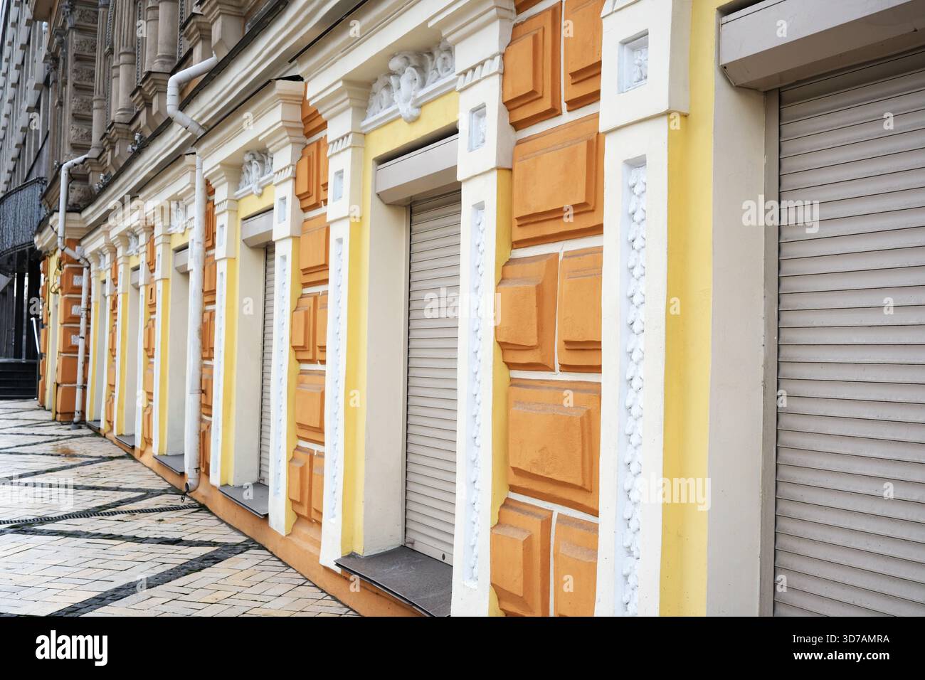 Colorful and detailed building facades stand closed along a peaceful urban street. Stock Photo