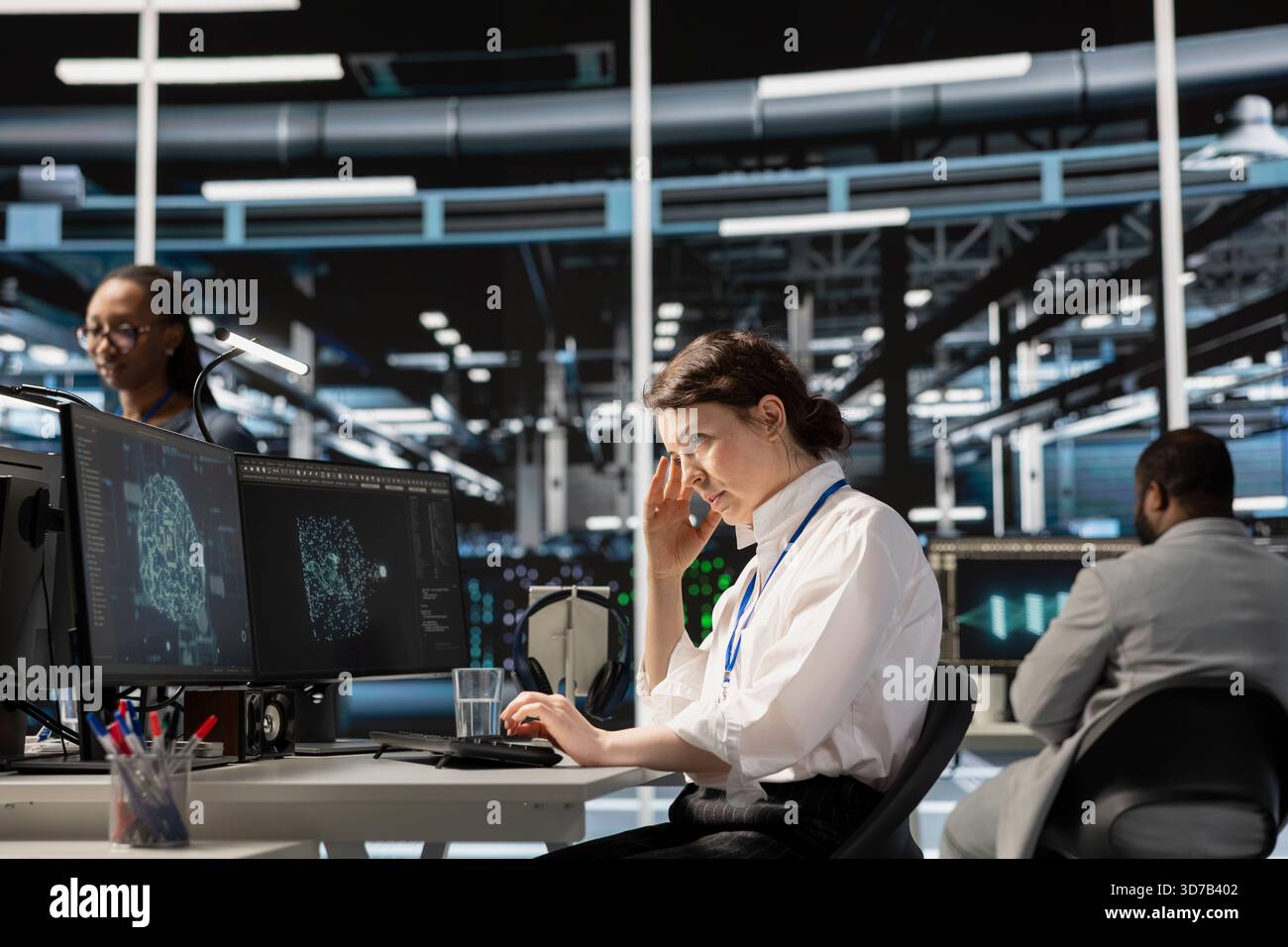 Overworked data center IT expert feeling headache while using artificial intelligence neural networks. Exhausted server farm developer having migraine from working too hard, using AI on computer Stock Photo