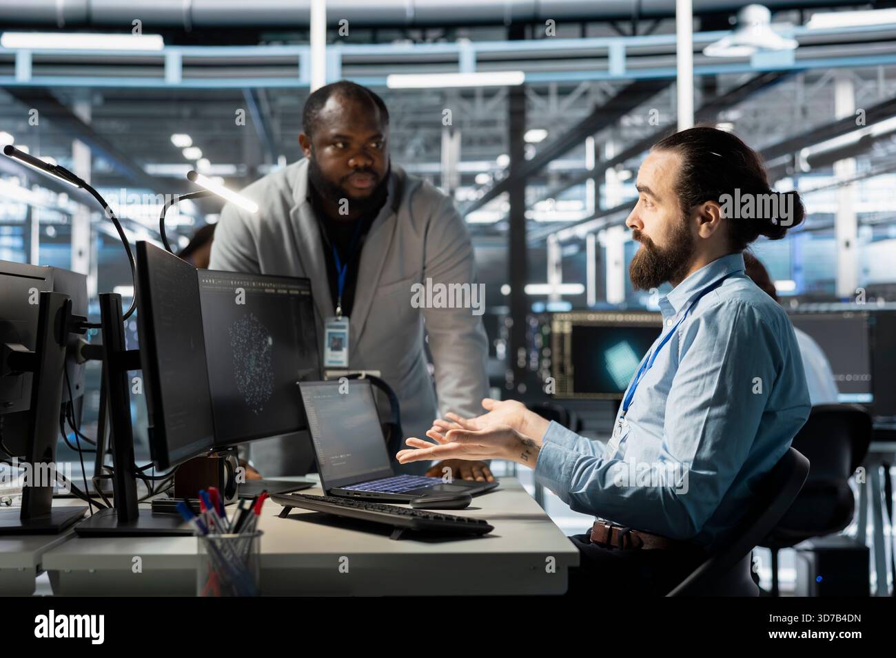 Team of computer scientists using PC in server farm, analyzing data ...