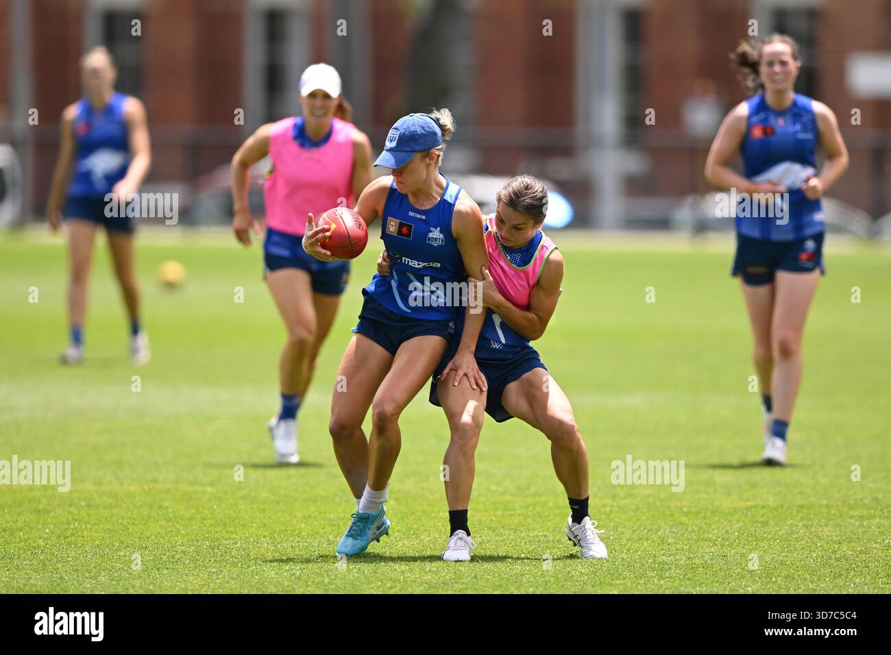 Ash Riddell of the Kangaroos (right) in action during a North Melbourne ...
