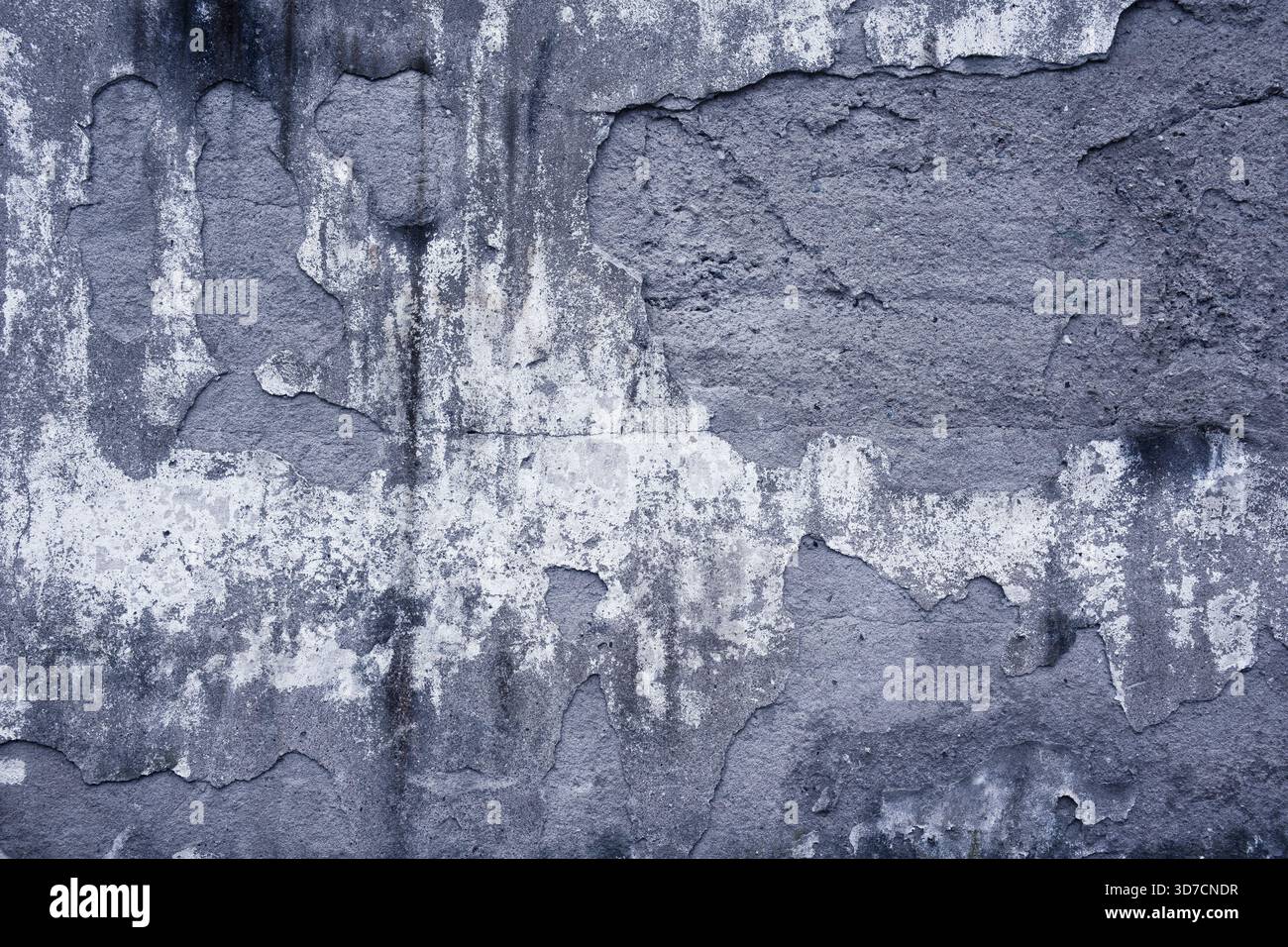 Decayed wall surface with cracks, stains, and weathered textures creating an abstract pattern Stock Photo