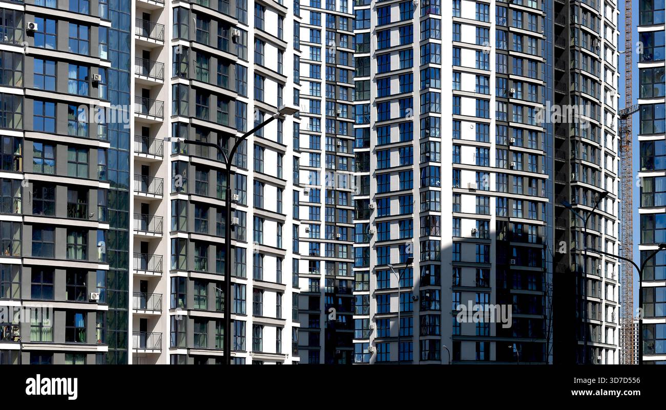 Architecture of modern highrise apartment buildings with glass facades ...