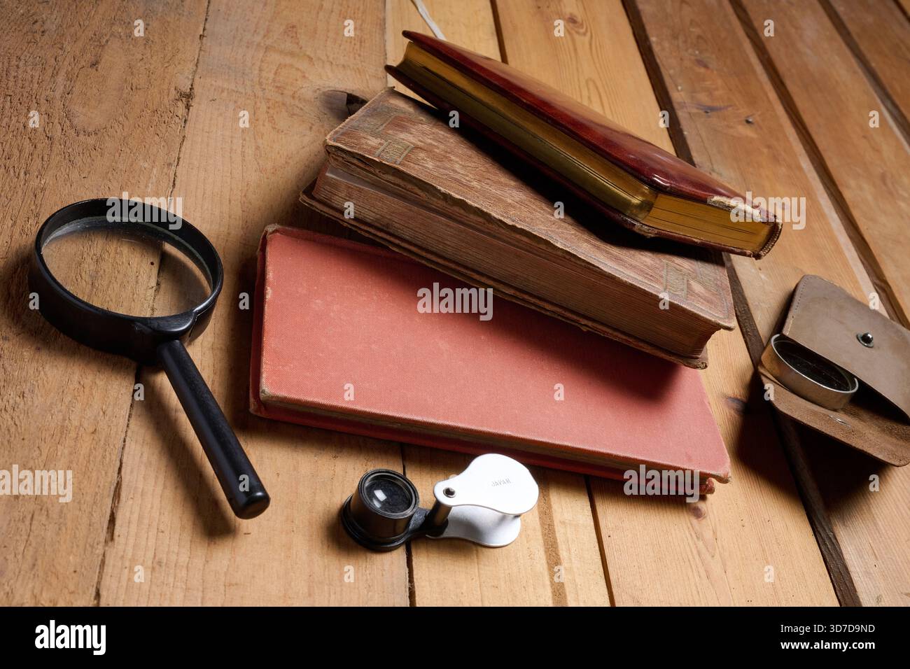 Old prayer books and reading magnifying glasses on wood Stock Photo