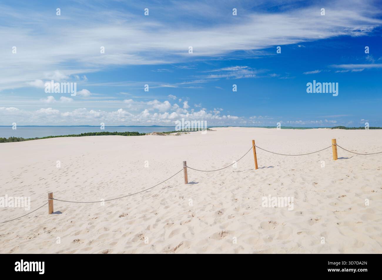 Beautiful landscape. Sand dunes. View of Lake Lebsko and the Baltic Sea. Fence made of wooden posts and ropes. Leba, Poland. Slowinski National Park. Stock Photo