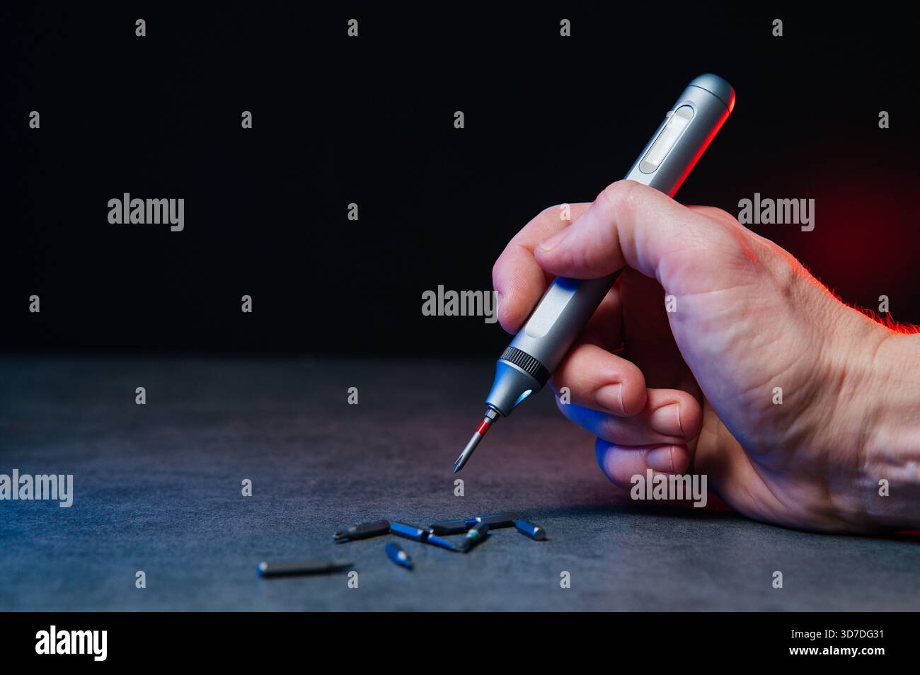 Electric mini screwdriver and several different interchangeable bits. Stock Photo