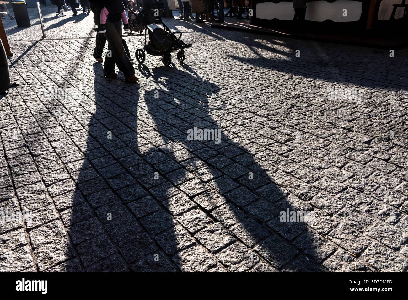 Shadows of people on the ground, low sun, winter, silhouettes, pram, Germany Stock Photo
