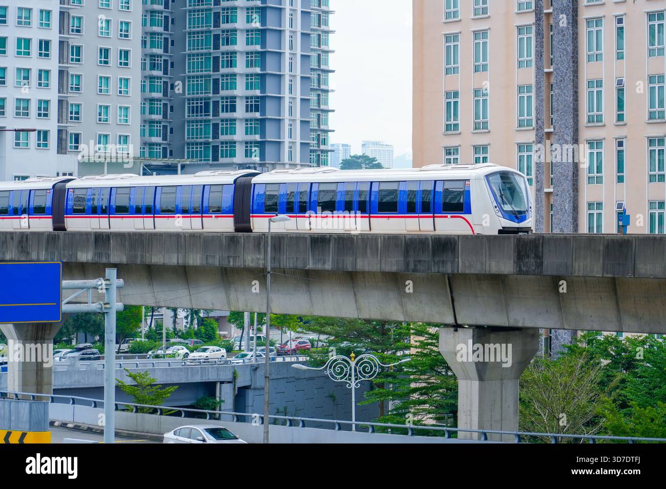 High-speed, driverless metro train travels across a city skyline on a ...