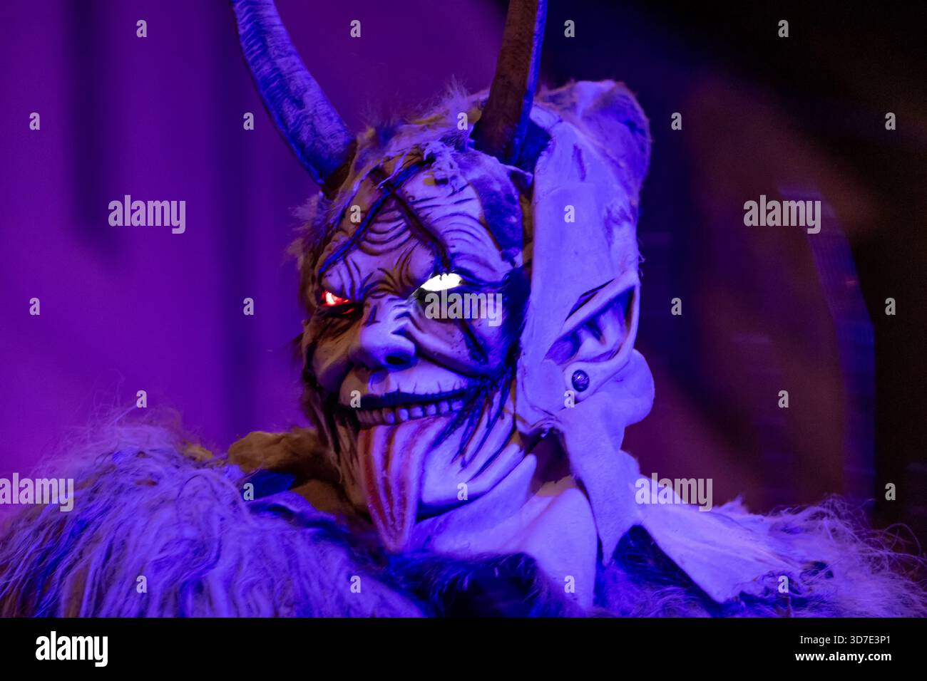 A frightening krampus with brightly lit eyes Stock Photo