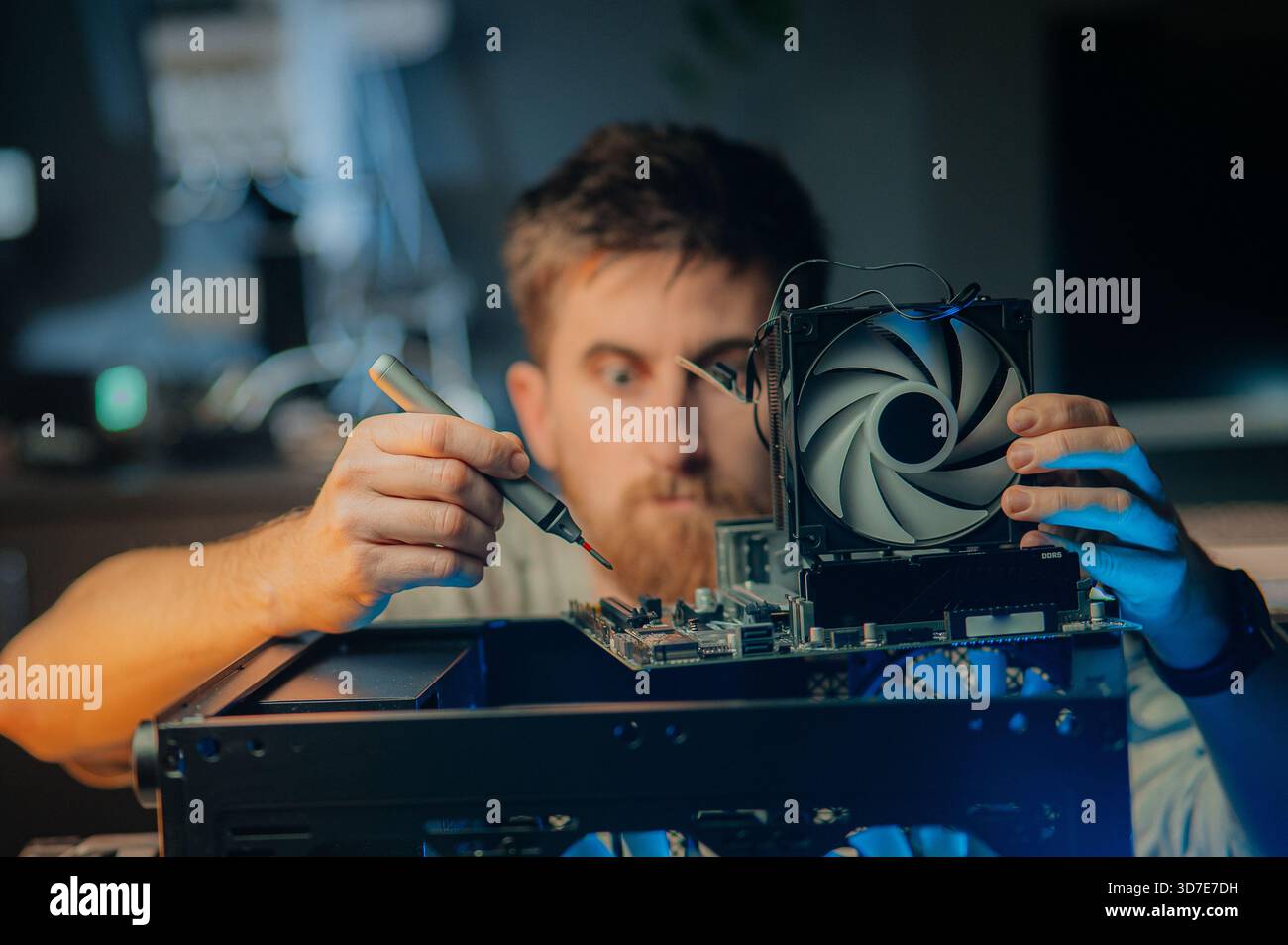 Man assembles a computer system unit at home Stock Photo