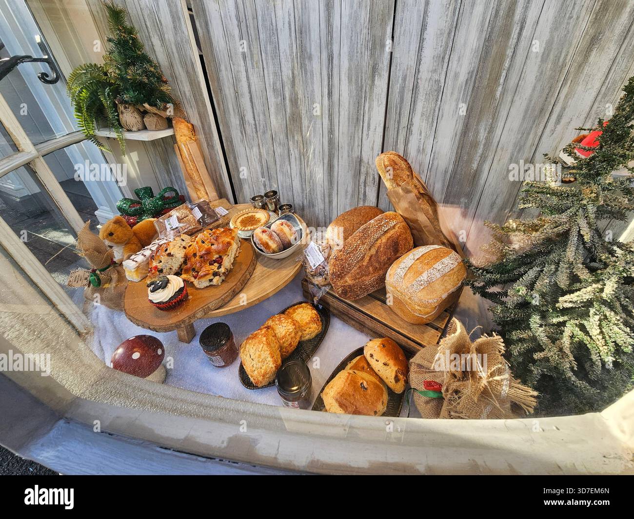 Bakery window display, Ambleside, Lake District, Cumbria Breads, pastries and cakes are attractively displayed in the window of an old bakery. - Smartphone Captured Stock Image