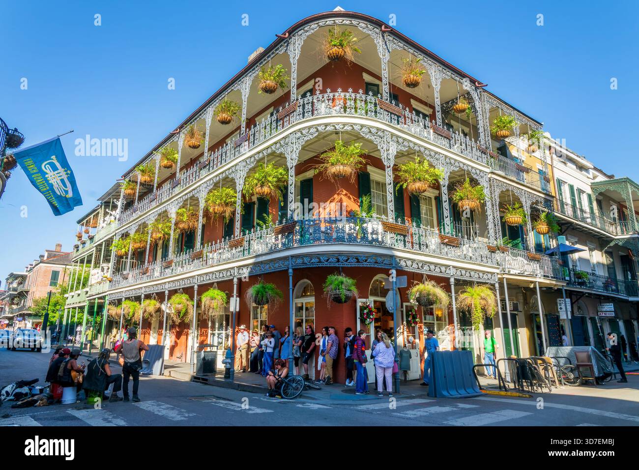 Music band, French Quarter Festival flag and historical LaBranche building with balconies and intricate ironwork columns in New Orleans, Louisiana Stock Photo