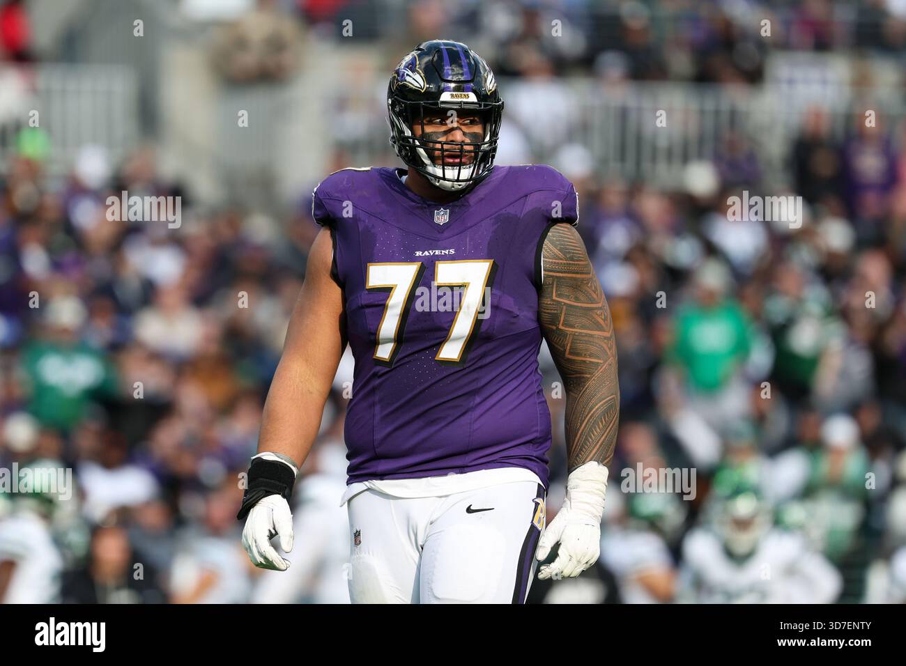 Baltimore Ravens guard Daniel Faalele (77) looks on between plays ...