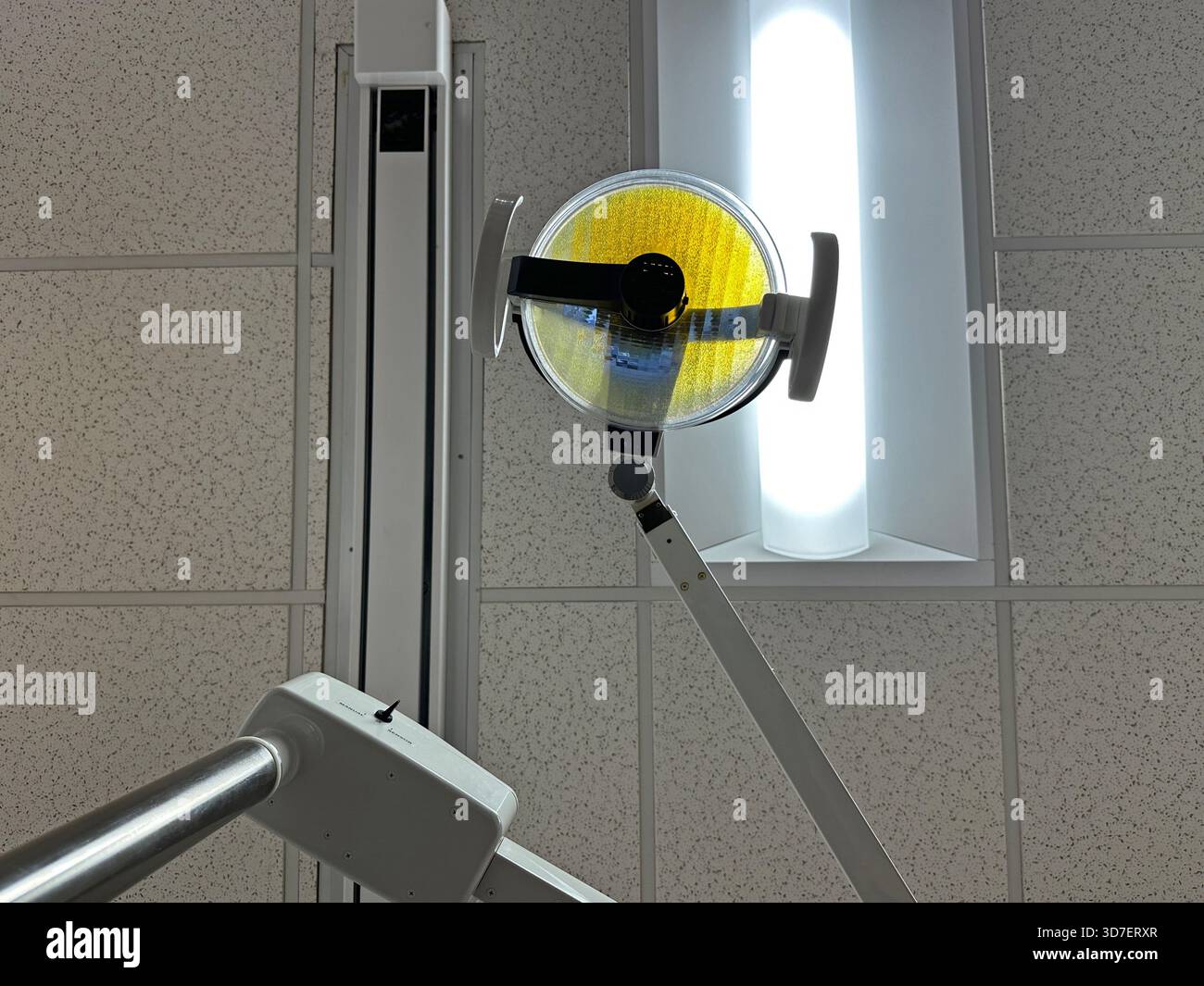 The overhead operatory lights and ceiling are shown from a patient’s chair POV perspective in a dentist office. - Smartphone Captured Stock Image