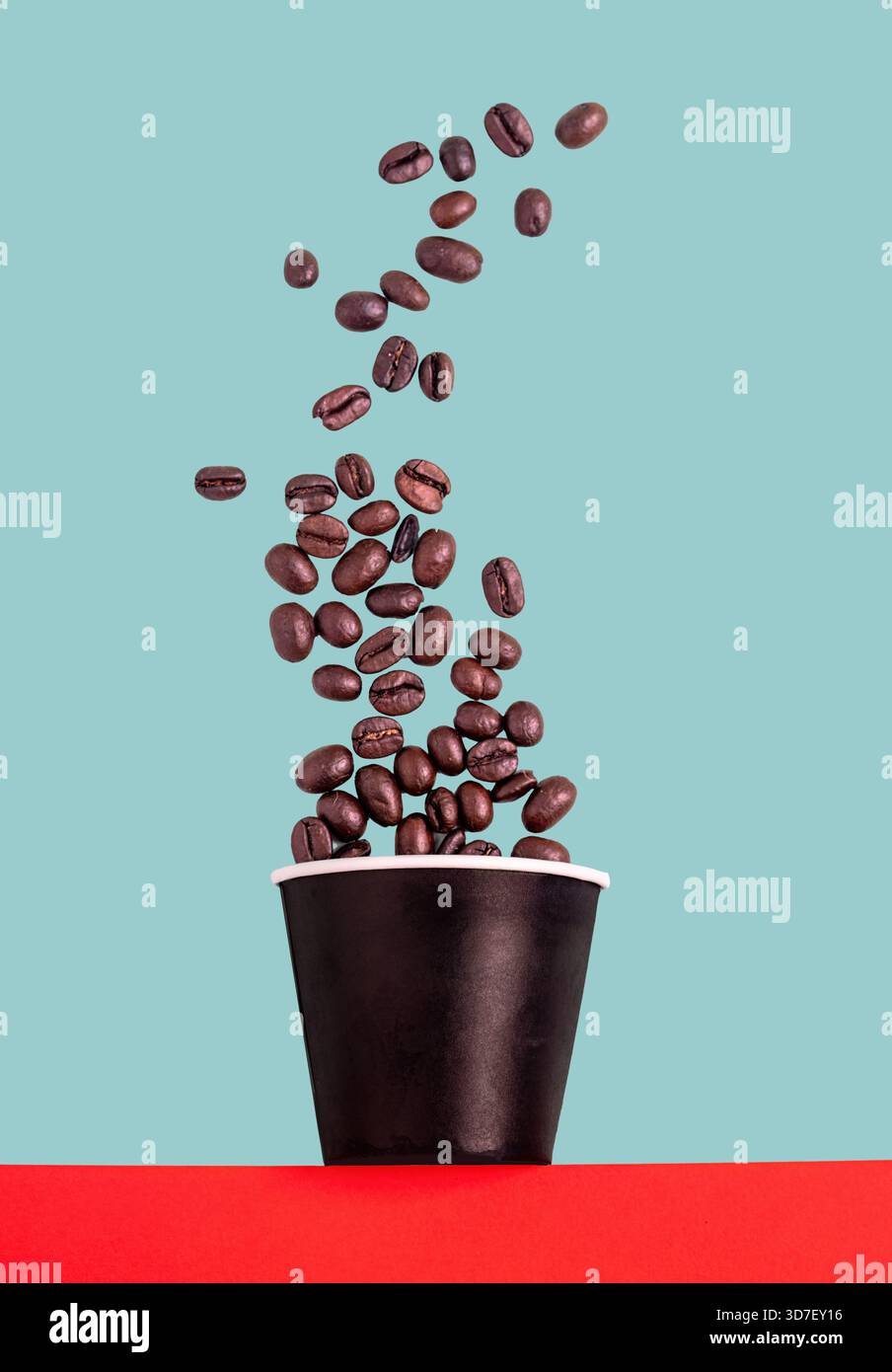 Coffee beans falling in to a paper cup Stock Photo