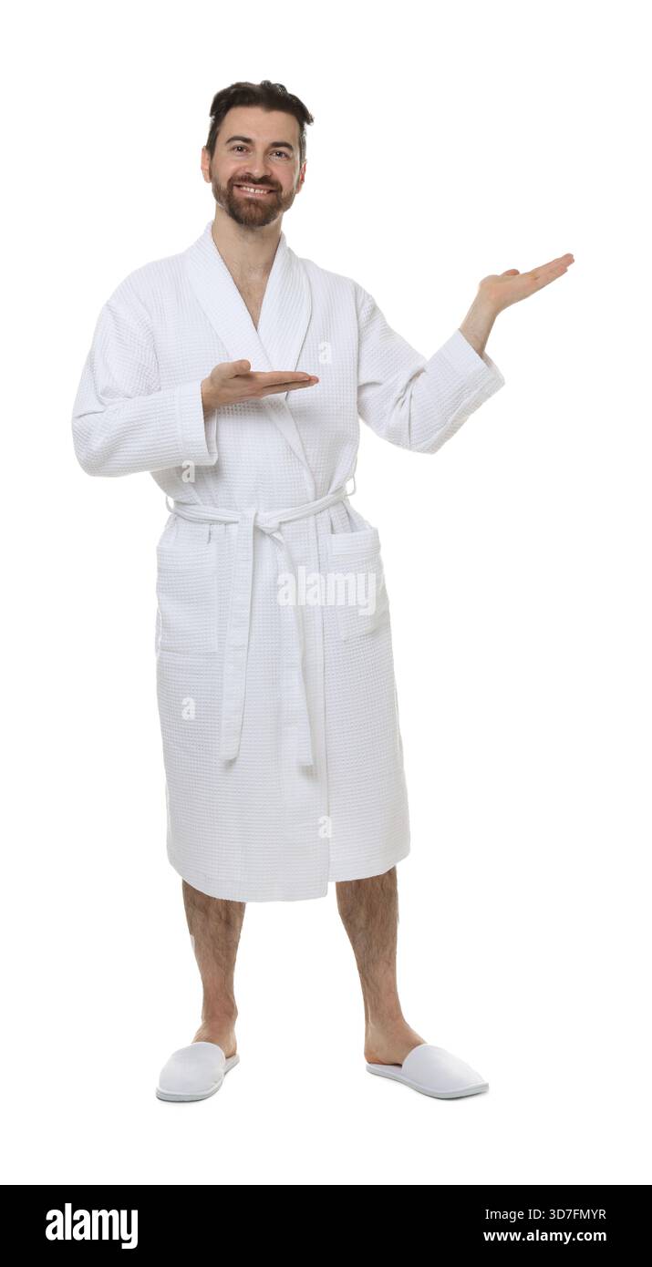 Man in bathrobe showing something on white background Stock Photo