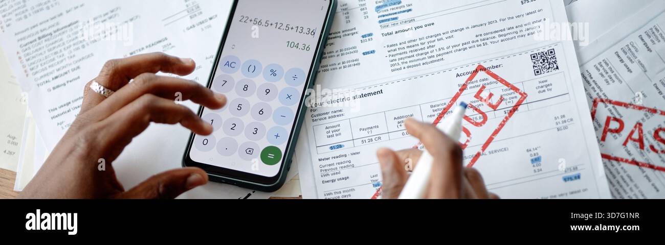 Young Woman Calculating Expenses While Analyzing Utility Bills Stock Photo
