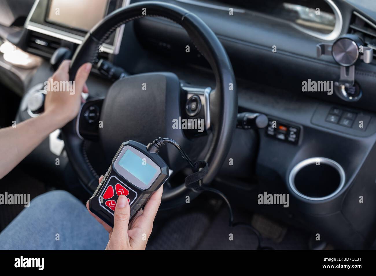 Woman using OBD2 diagnostic scanner.  Stock Photo