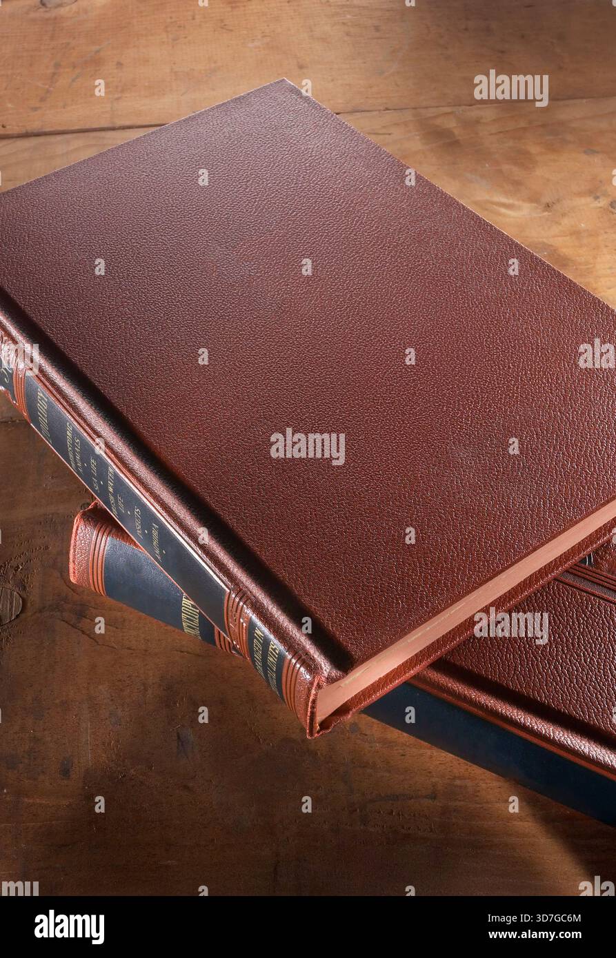 Looking down on stack offered leather bound books, USA Stock Photo
