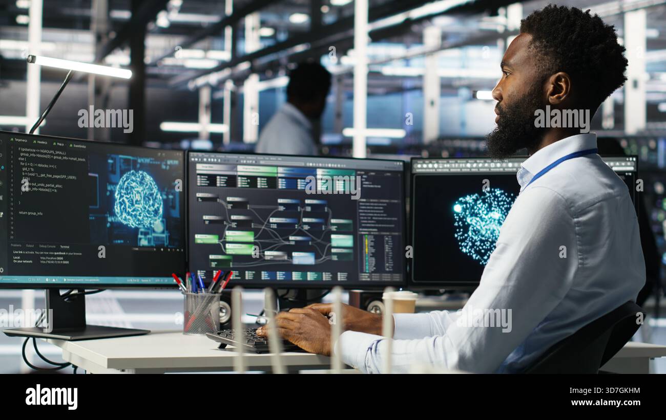 Data center programmer uses machine learning node tree program to identify equipment issues. Server hub worker reviewing artificial intelligence data analysis graph to minimize failures, camera B Stock Photo