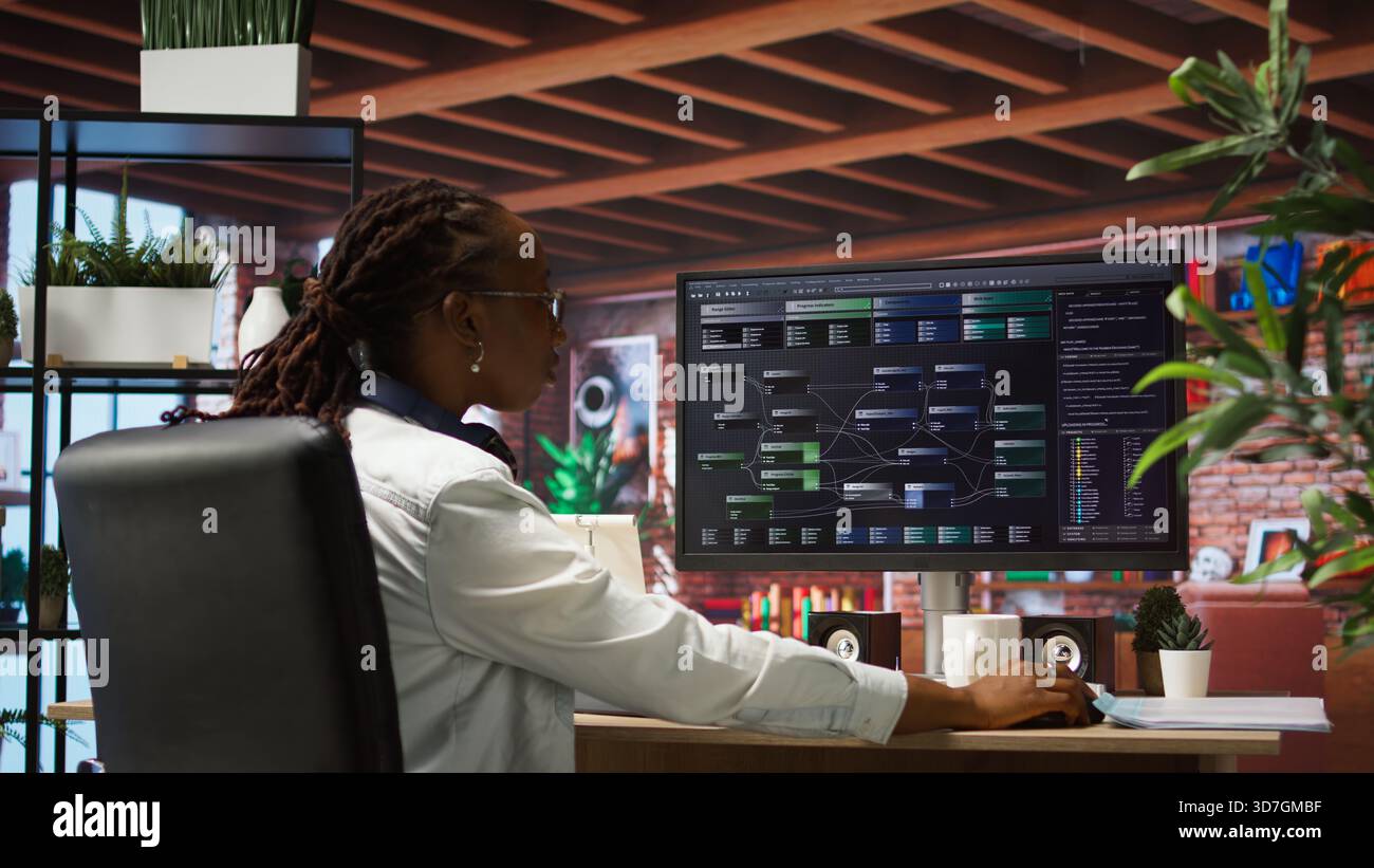 Teleworking programmer using computer for artificial intelligence computing through self learning algorithms. Remote worker working with AI deep neural networks on desktop PC, camera A Stock Photo