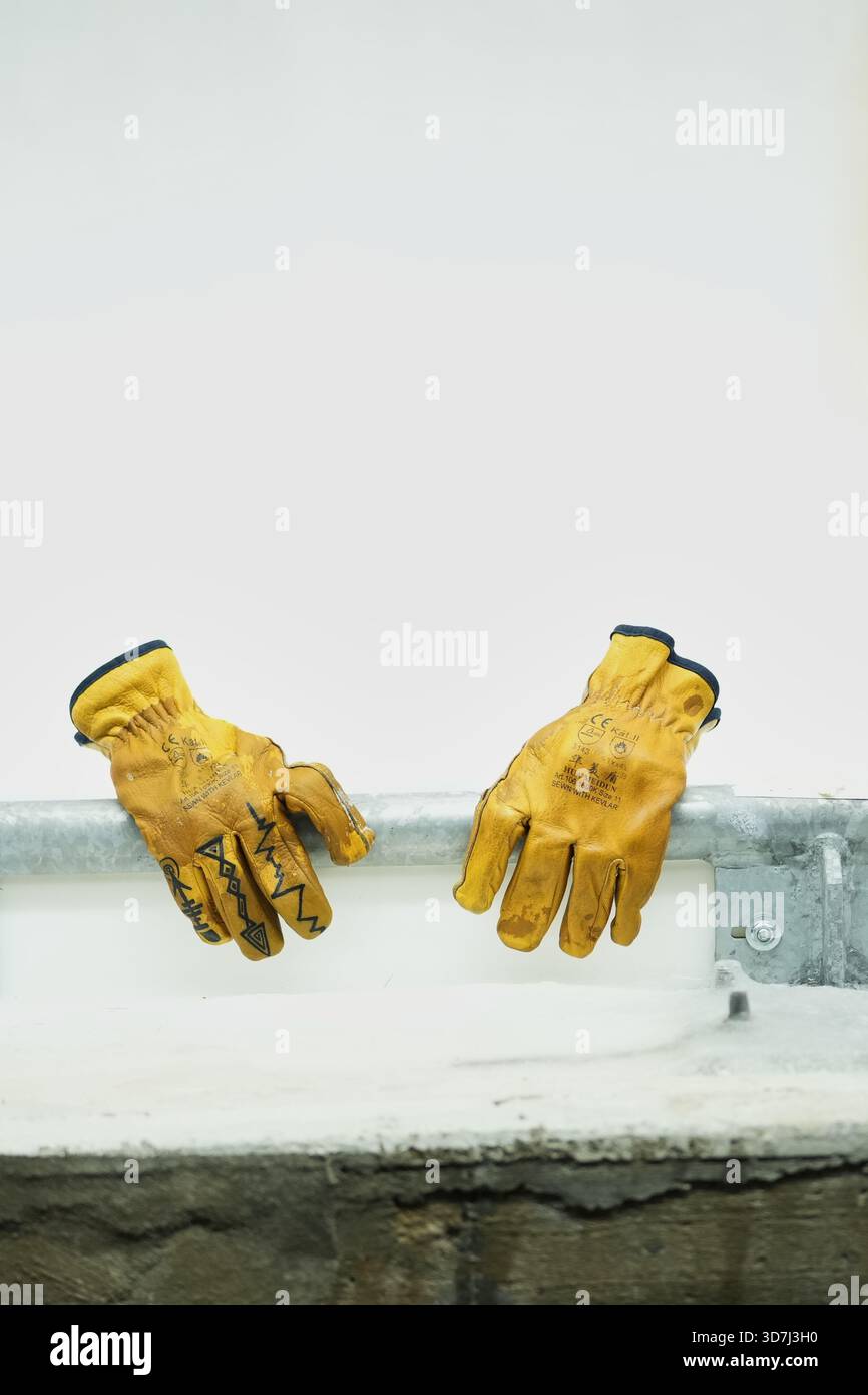 FILE - A worker's gloves are propped on the railing of a sliding track ...