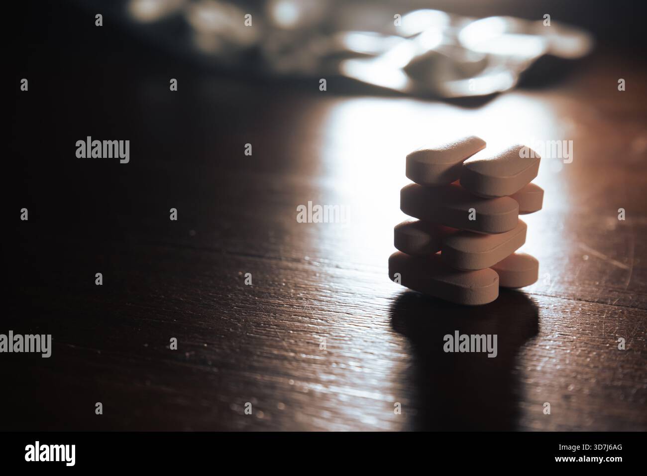 Stack of oval-shaped pills on table Stock Photo