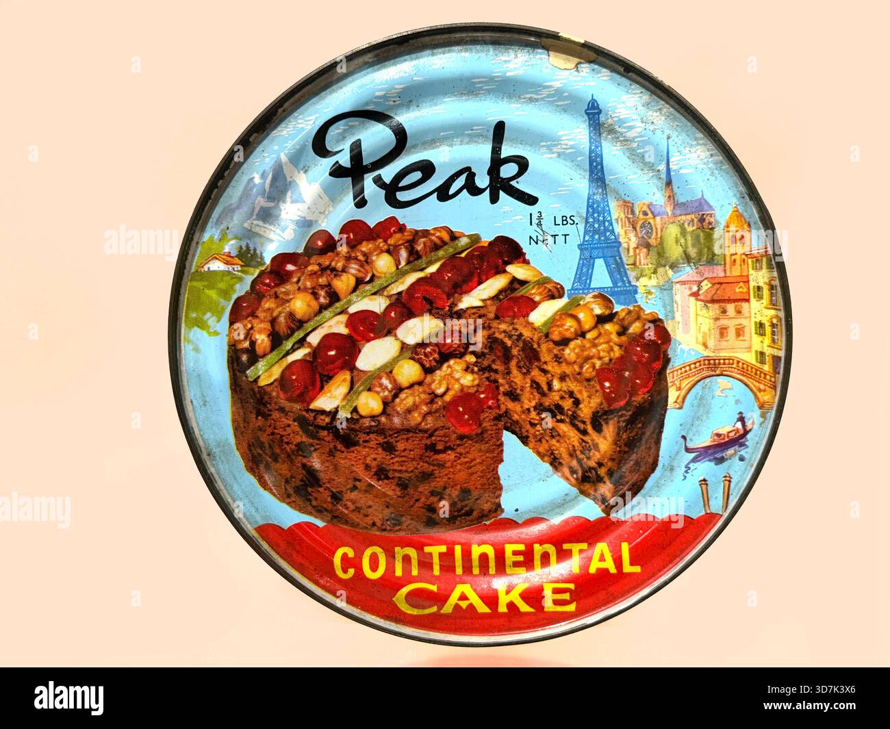 Vintage tin container for Peak Continental Cake with colorful illustrations of European landmarks and a fruitcake image on the lid - Smartphone Captured Stock Image