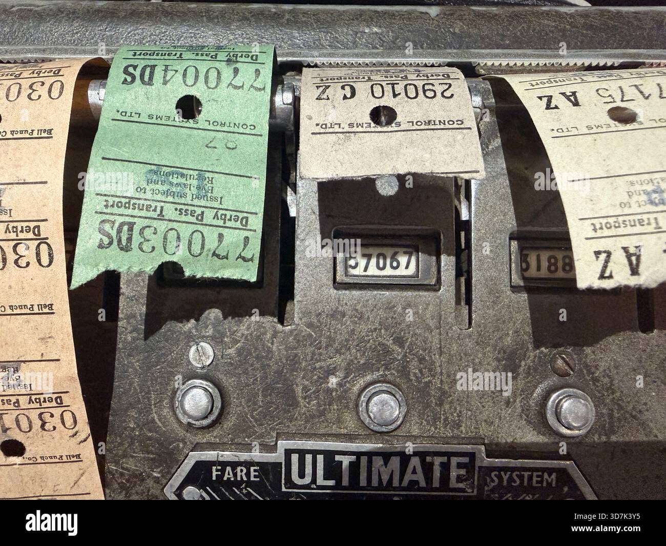 Close-up of a vintage mechanical fare ticket machine with old paper bus tickets in various colors and serial numbers - Smartphone Captured Stock Image