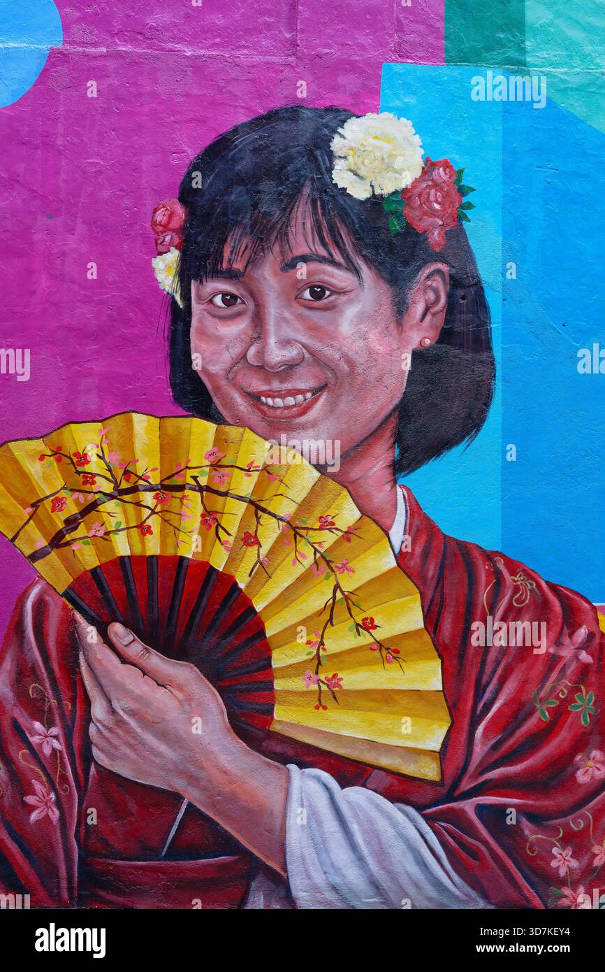 Girl with flower in hair and a fan, Street art murals in Pasar Karat, Chinatown, Kuala Lumpur Stock Photo