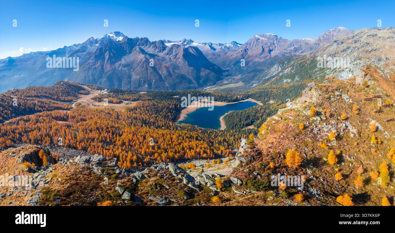 Aerial view of the Palù lake in autumn during foliage. Chiesa in Valmalenco, Valmalenco, Sondrio province, Valtellina, Lombardy, Italy, Europe. Stock Photo