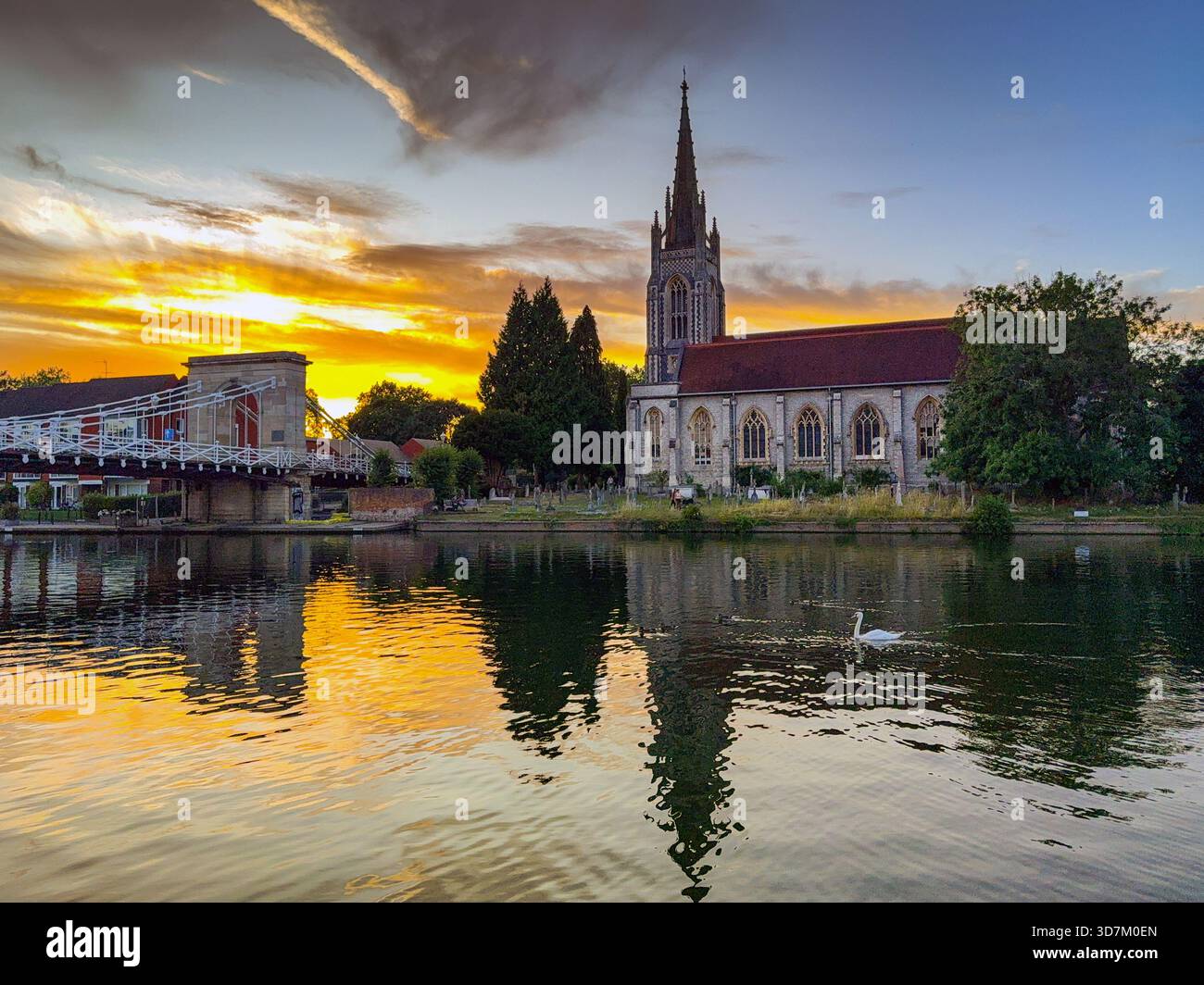 Marlow, Buckinghamshire, England, UK - 20 July 2025: Scenic view of All Saints Church and the chain bridge in Marlow with a reflection in the Thames - Smartphone Captured Stock Image