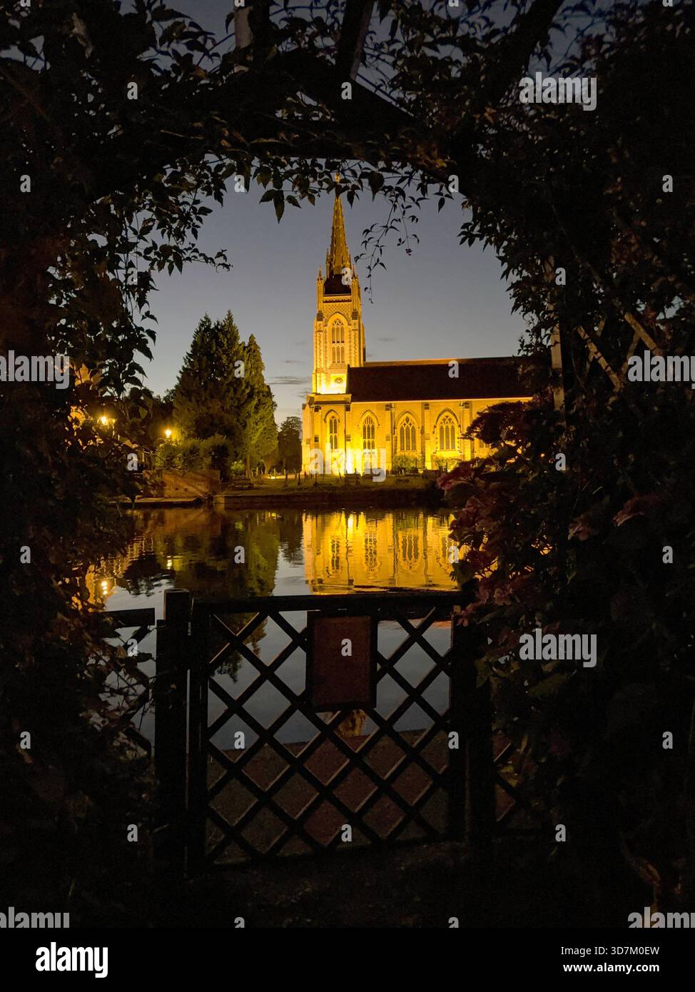 Marlow, Buckinghamshire, England, UK - 20 July 2025: Scenic view of All Saints Church in Marlow seen through the arch of a garden with a reflection in - Smartphone Captured Stock Image