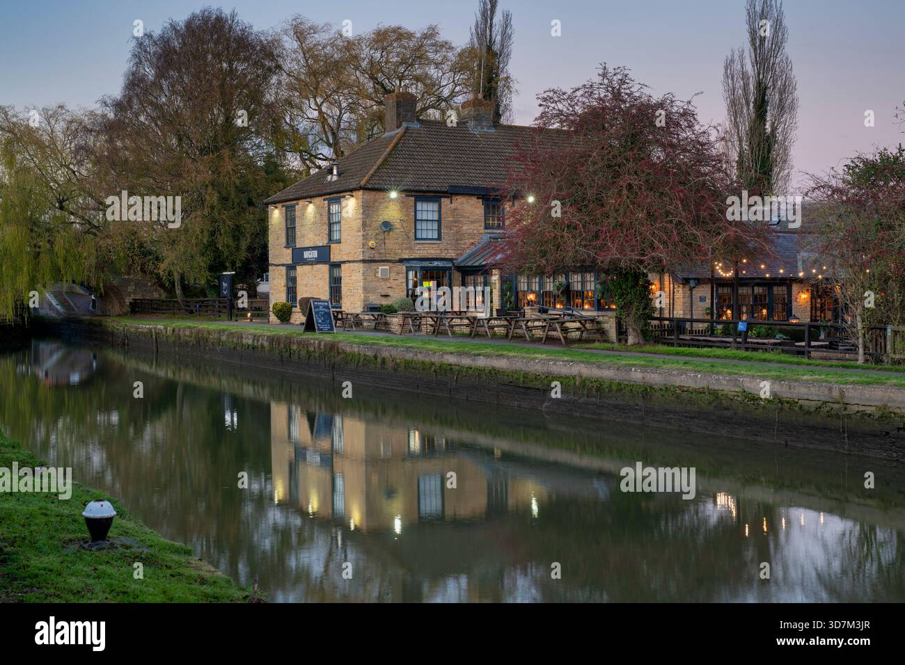 The Navigation pub on the Grand Union Canal at Stoke Bruerne in the Autumn at Dusk. Northamptonshire, England. Stock Photo