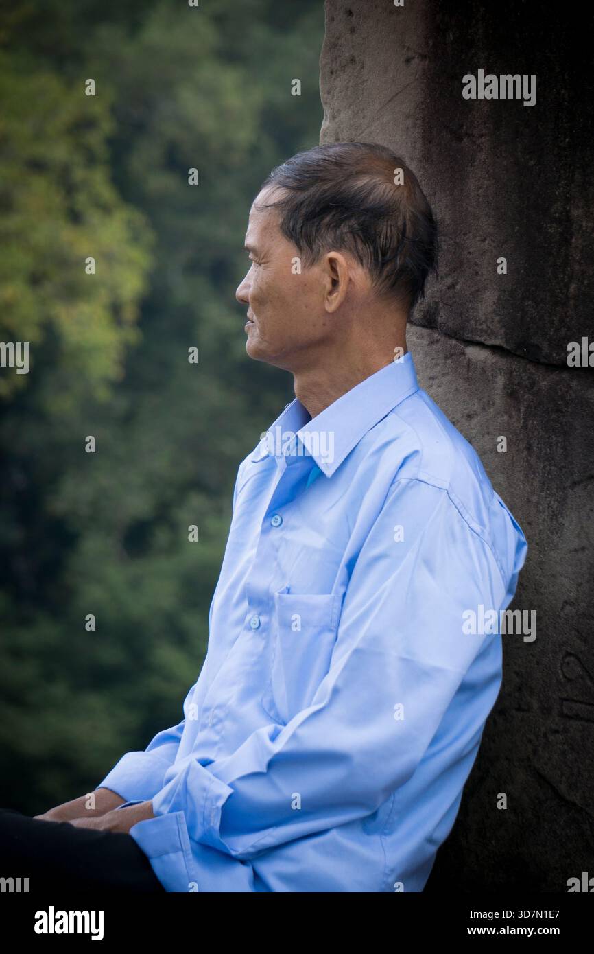 Seated man in blue hi-res stock photography and images - Alamy