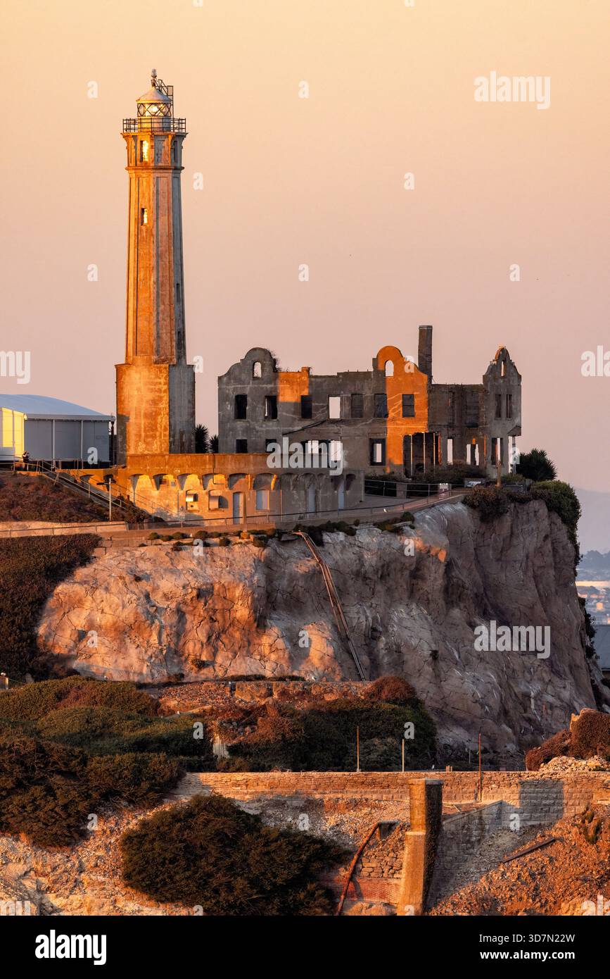 Alcatraz Island Lighthouse in the warm glow of sunset, Alcatraz Island - San Francisco, California, USA Stock Photo