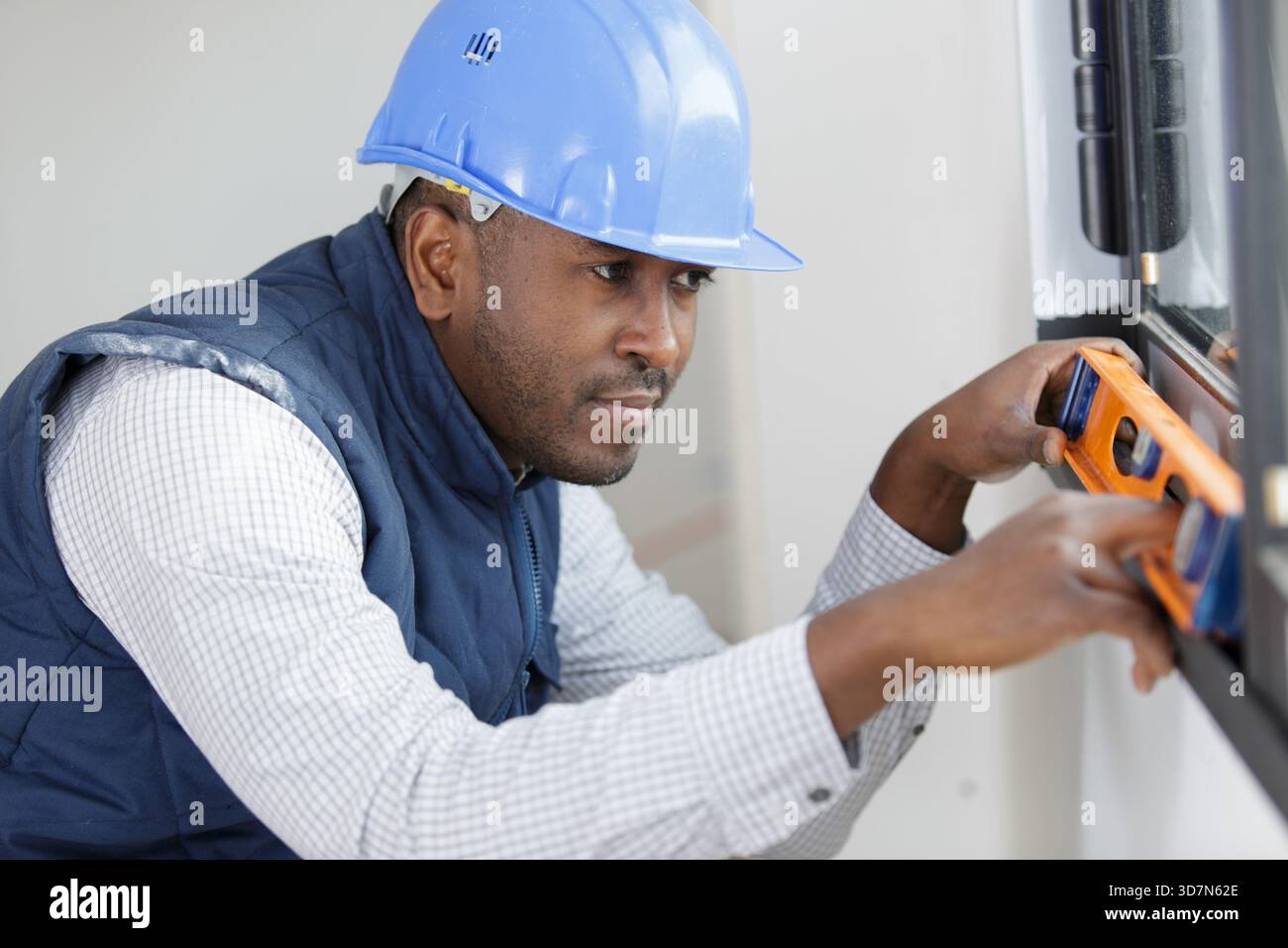 specialist for installing plastic windows checks the level Stock Photo