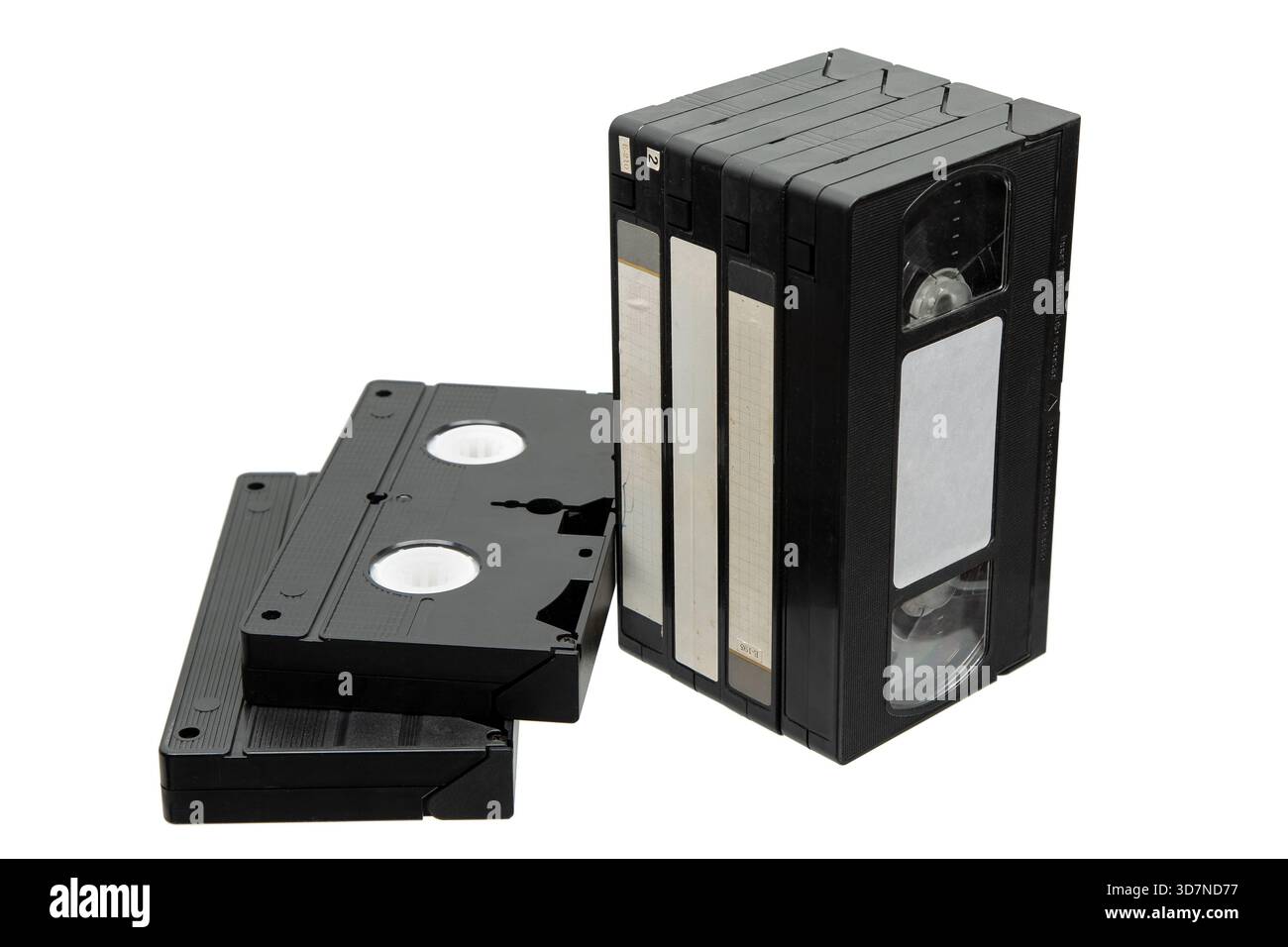 Stack of black VHS tapes and two lying flat, isolated on a white ...