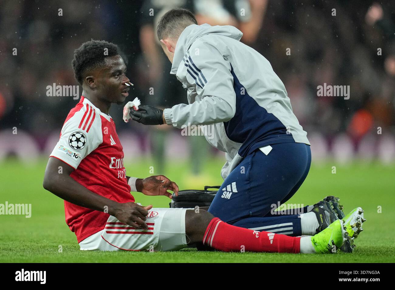 Arsenals bukayo saka receives treatment during the champions league opening phase soccer match between arsenal and bayern mun
