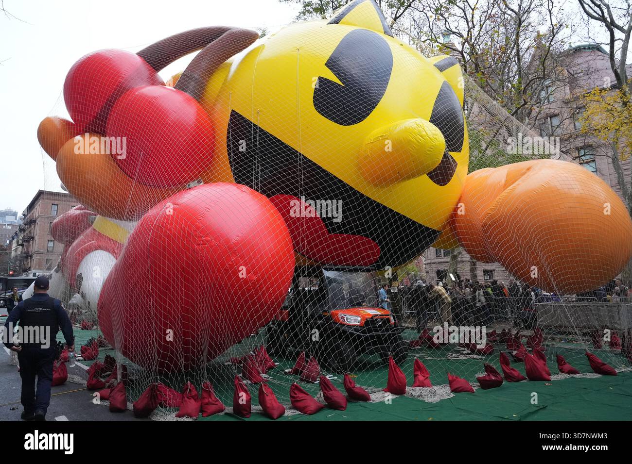 Peoplel pass Pac-Man during the balloon inflation for the 99th Macy's ...