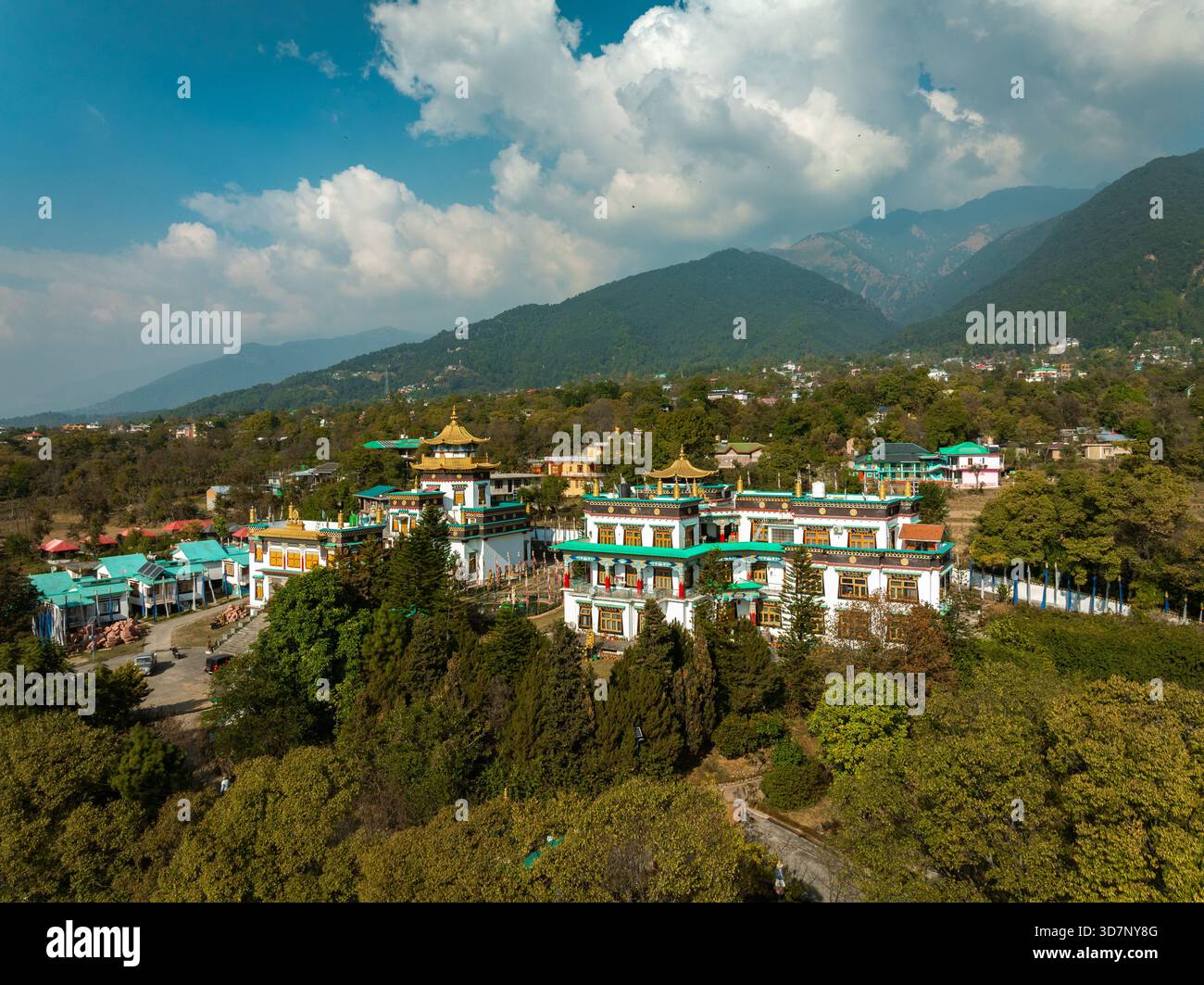 Aerial view of a Buddhist monastery complex with golden rooftops amidst ...