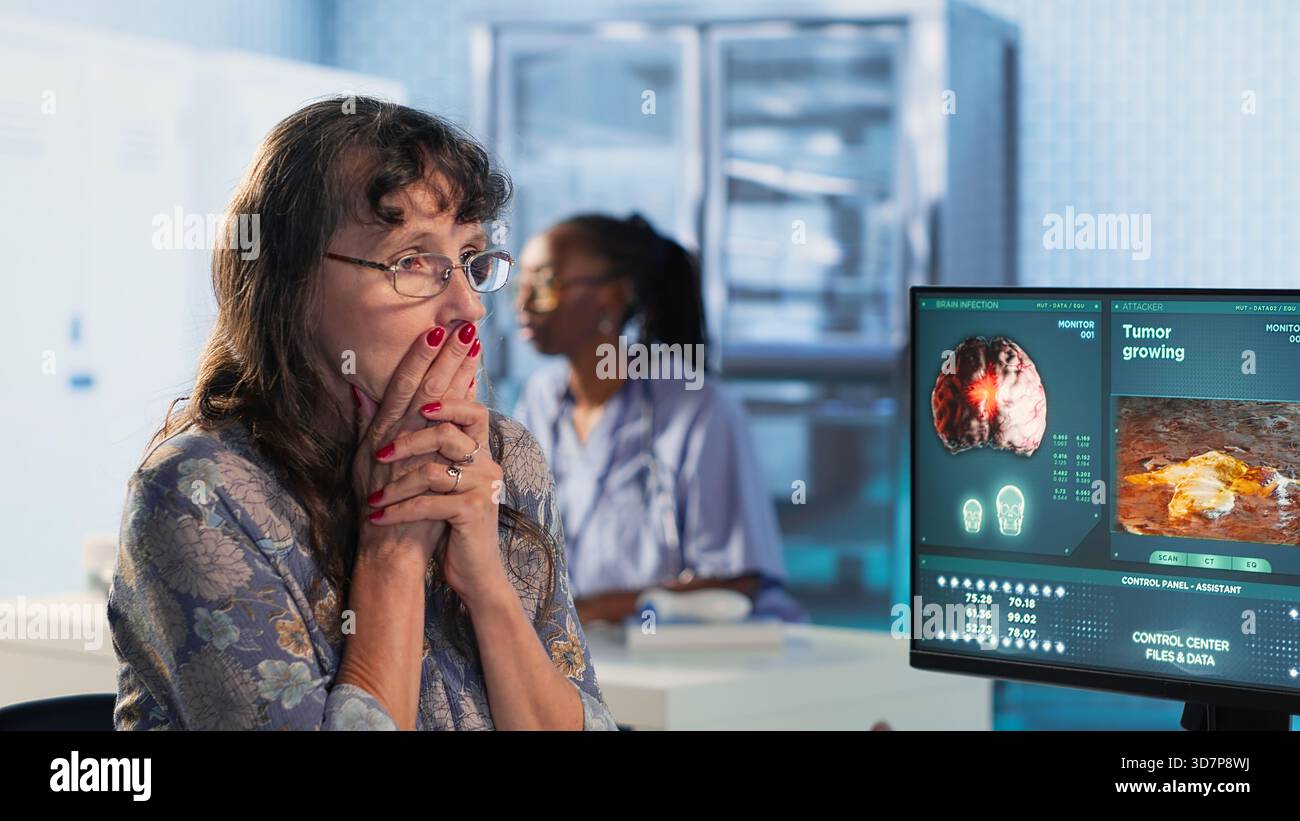 Male oncology specialist reviewing a radiology scan with elderly woman ...
