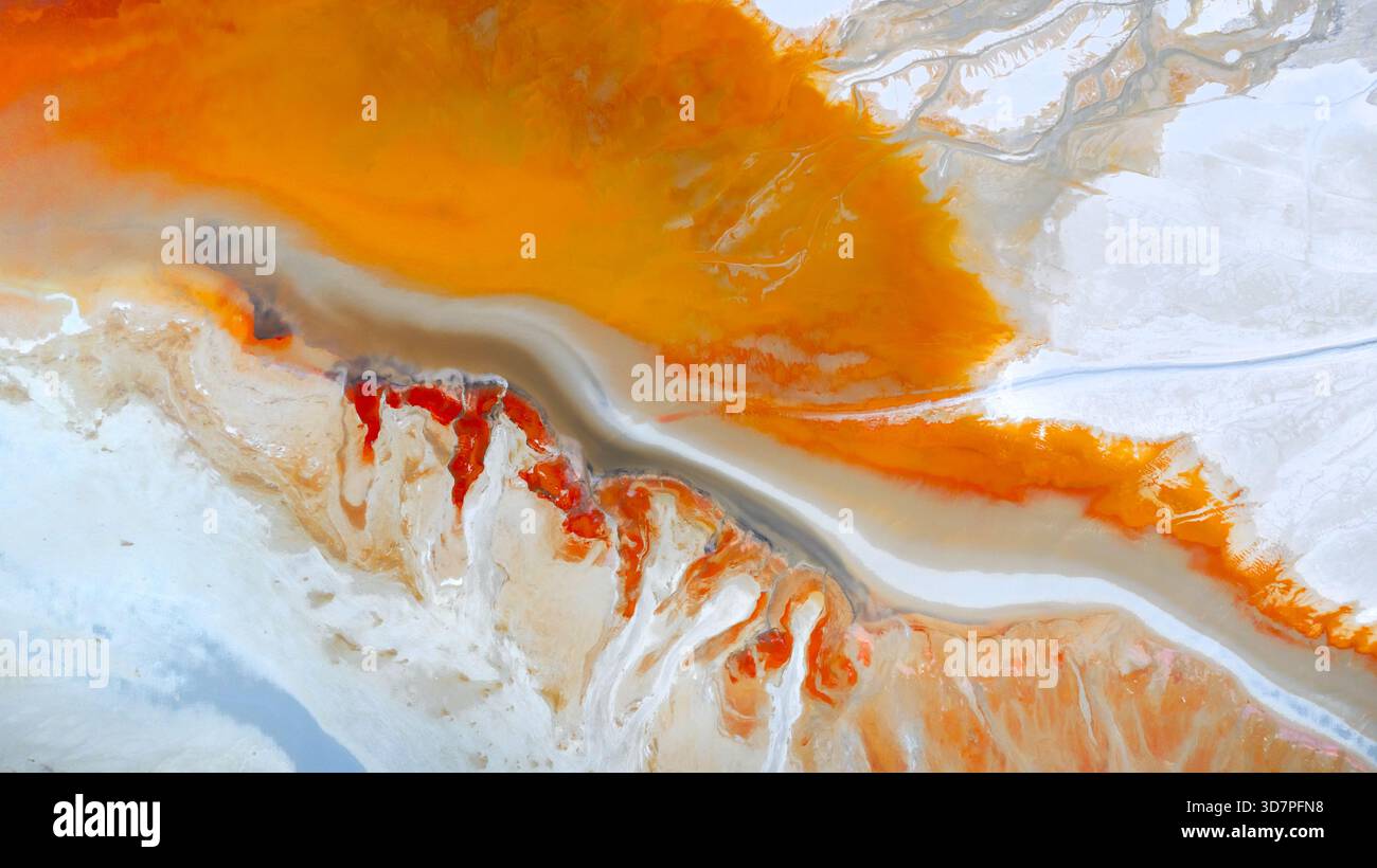 Aerial view of a surreal landscape where vibrant orange rivers carve ...