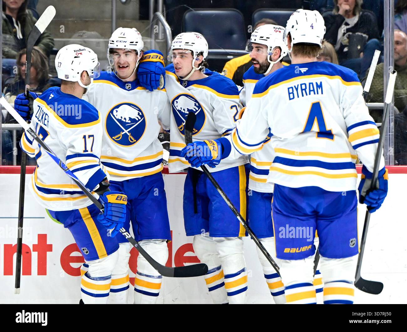 Buffalo Sabres left wing Jason Zucker (17) joins the celebration of his ...