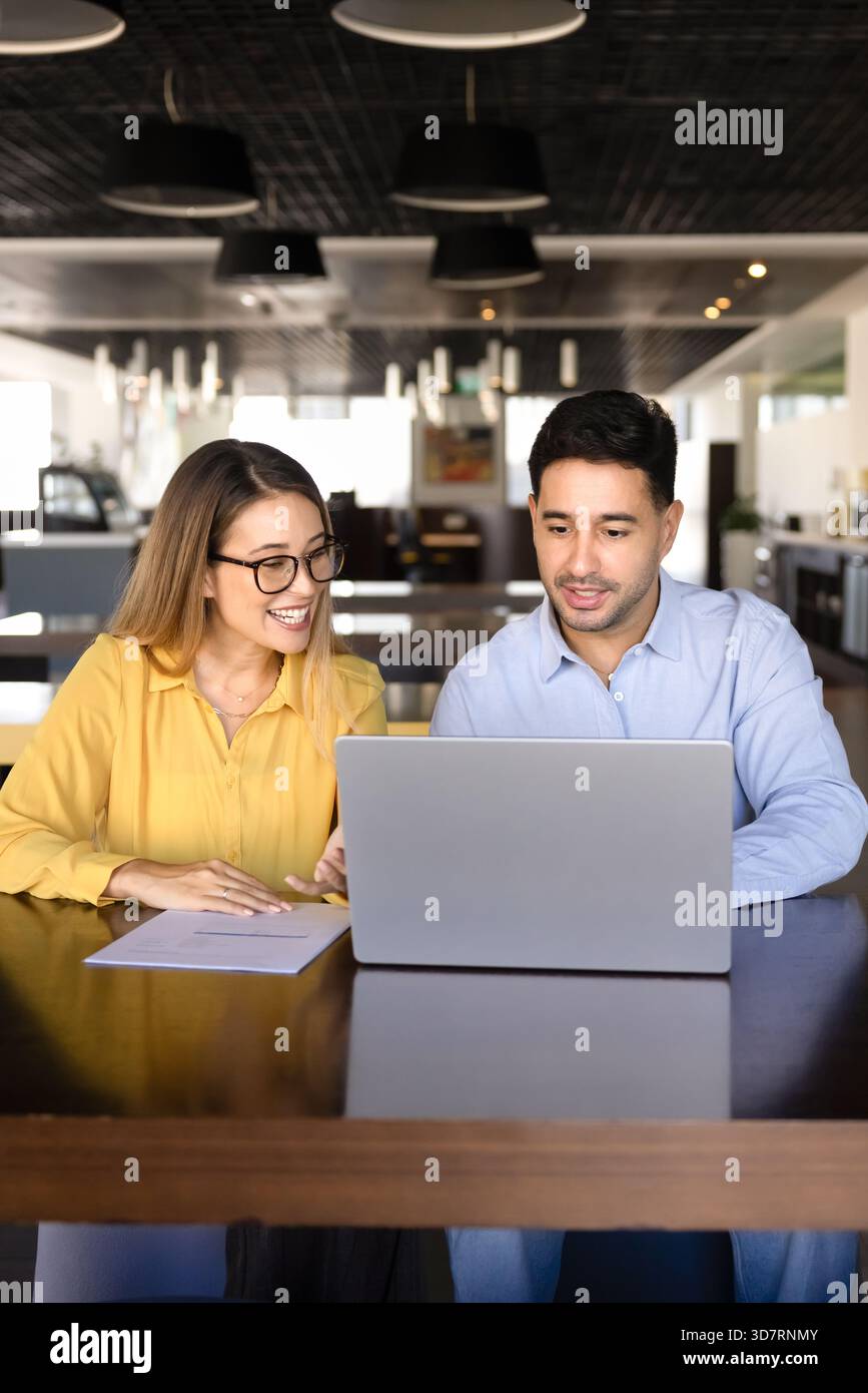 Happy diverse managers working on project task together Stock Photo