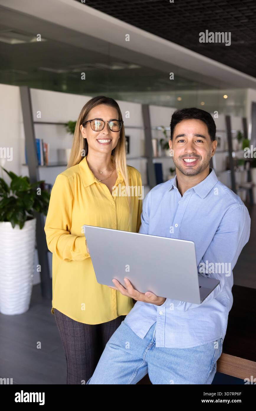 Two happy young professional partners standing together Stock Photo