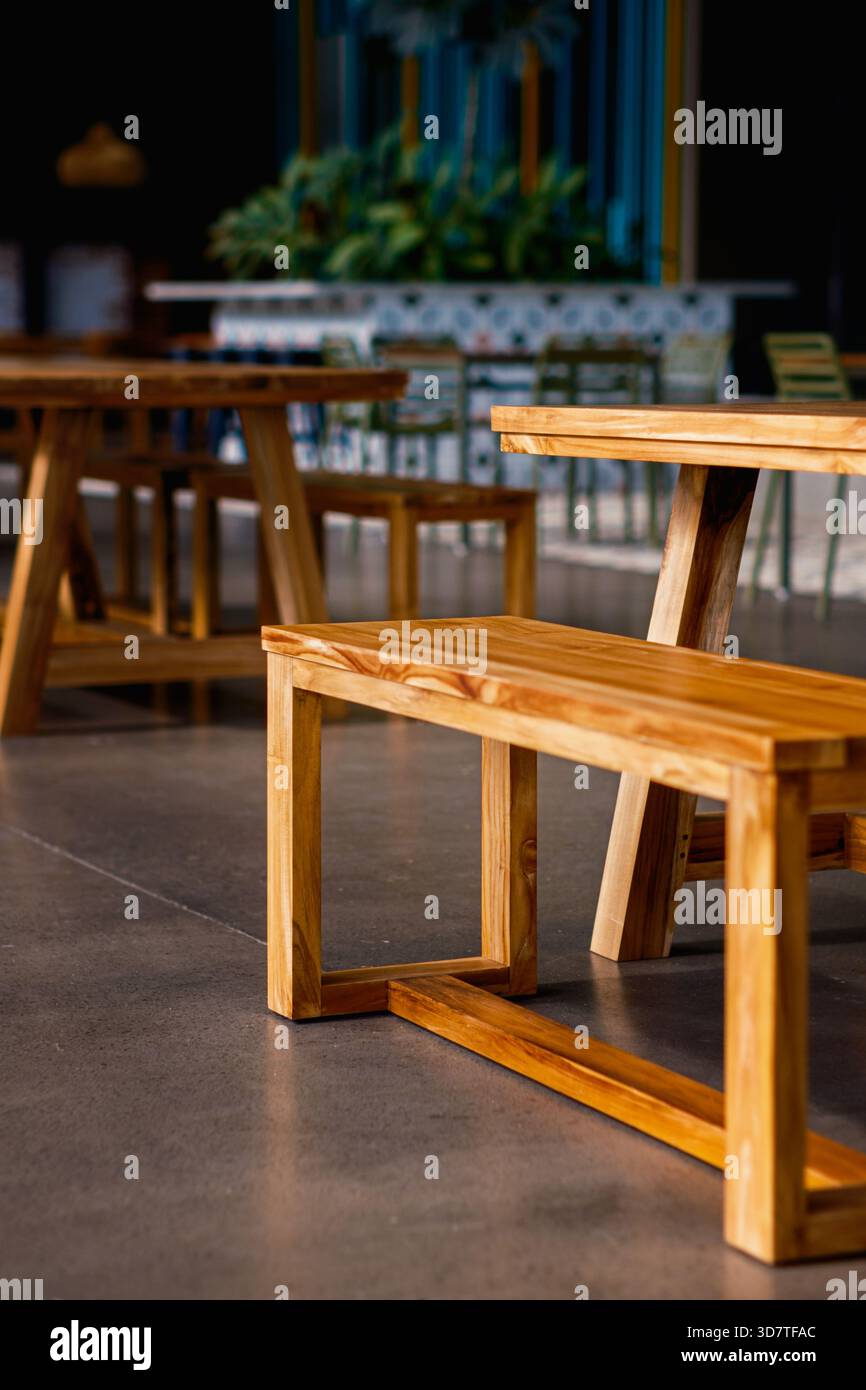 Clean lines of modern wooden benches and tables in a contemporary cafe ...