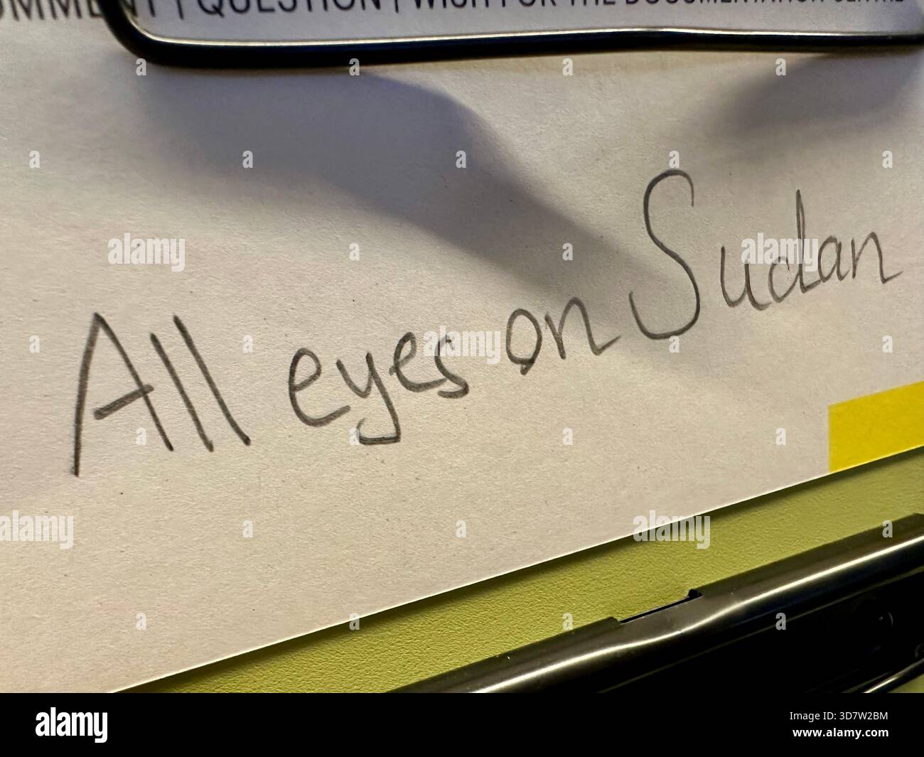 All eyes on Sudan written on paper - Smartphone Captured Stock Image