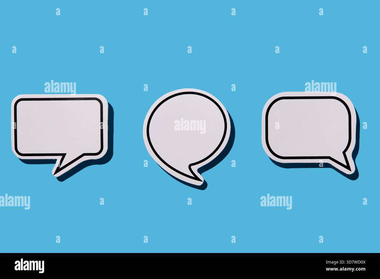 Blank white thought bubbles on blue background Stock Photo