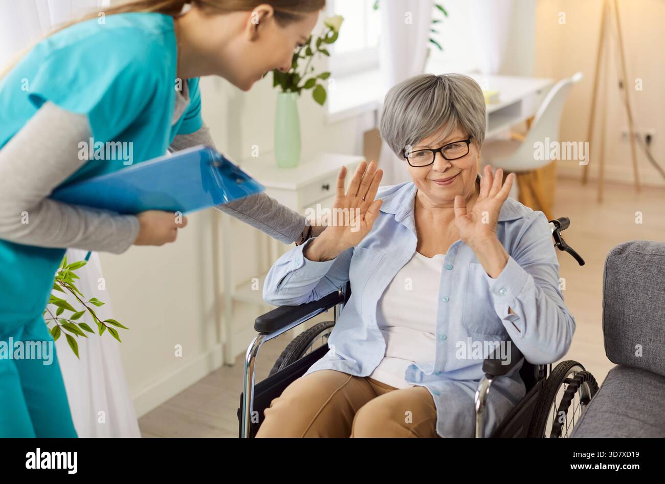 Senior disabled woman in wheelchair refusing the help and support from ...